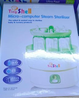 27 Sterilisateur avec 6 biberons 35000